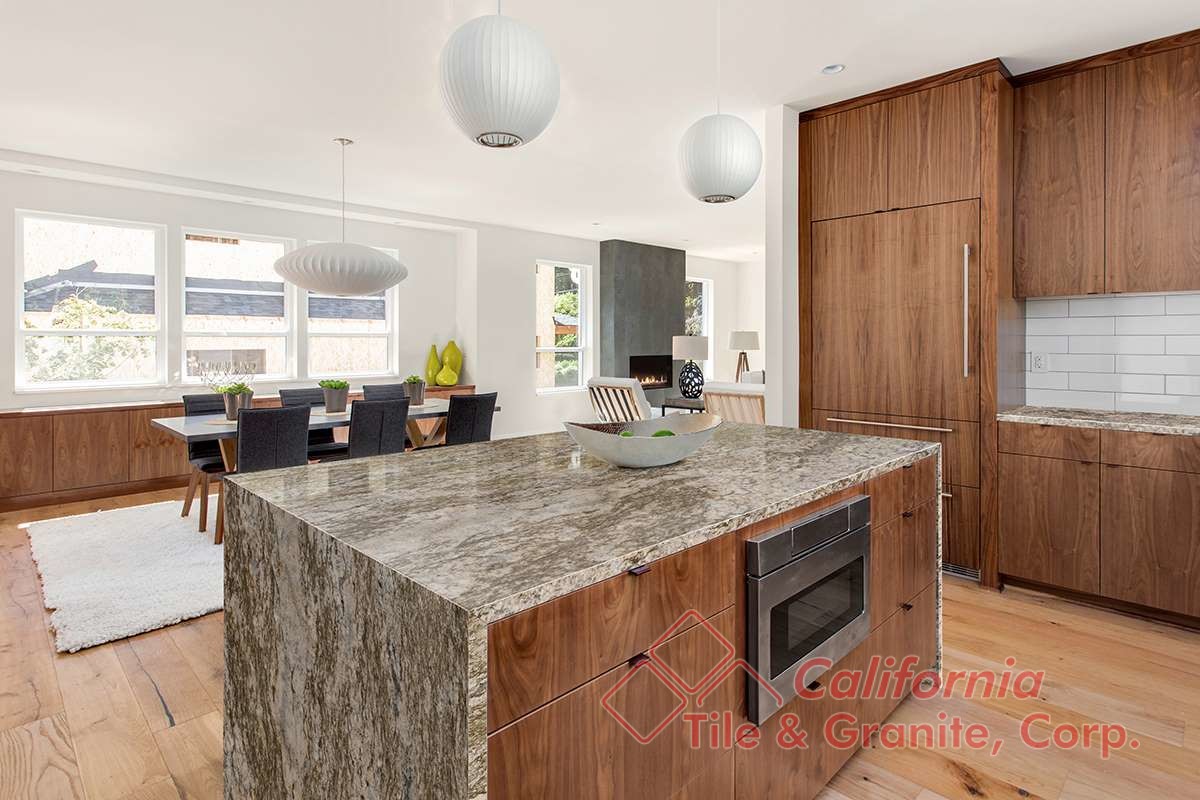 beautiful kitchen in new luxury home with island, pendant lights, and hardwood floors. Has view of Dining Room